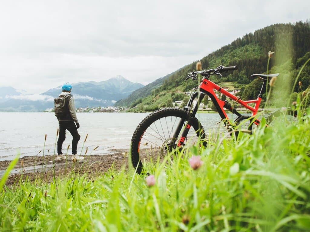 mountain biker looking at a lake wearing a backpack